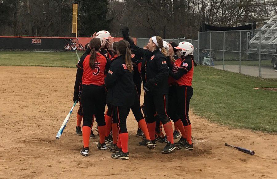 The team celebrates as Lyndsey Lyon hit a home run to extended their lead to 8-0.