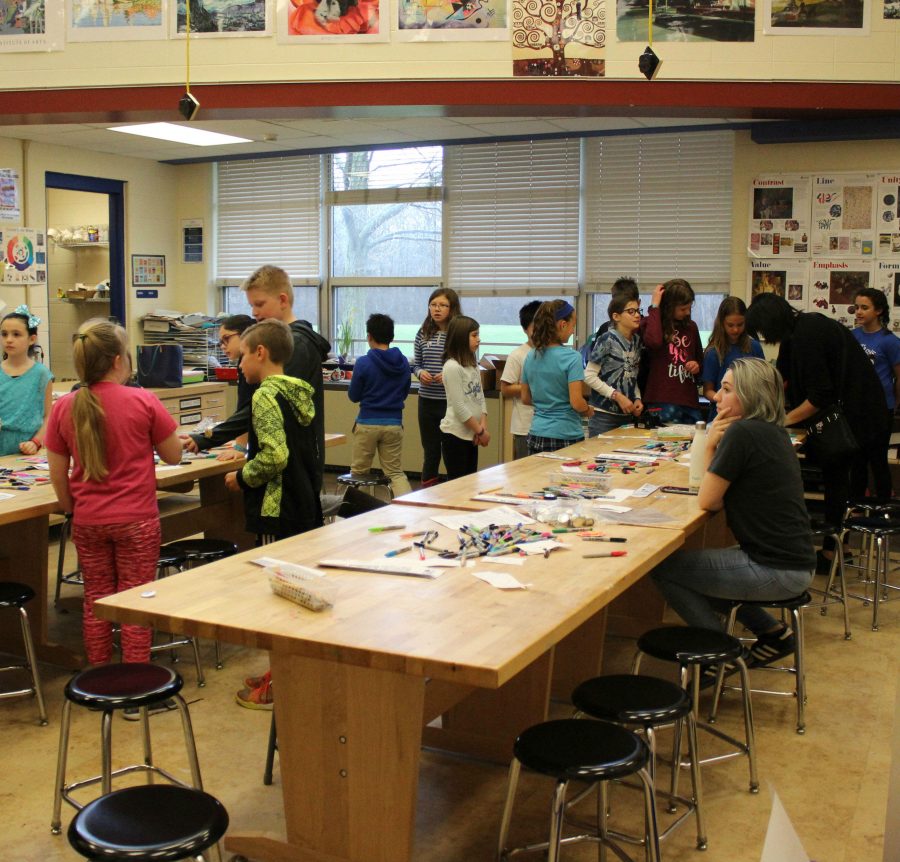 In the junior high art room, students came to the LHS 3D Art station, where they designed and pressed their own buttons.