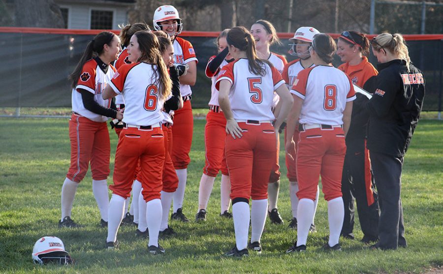 The team and their coaches celebrate and talk after their 11-1 win over Buffalo Grove. 