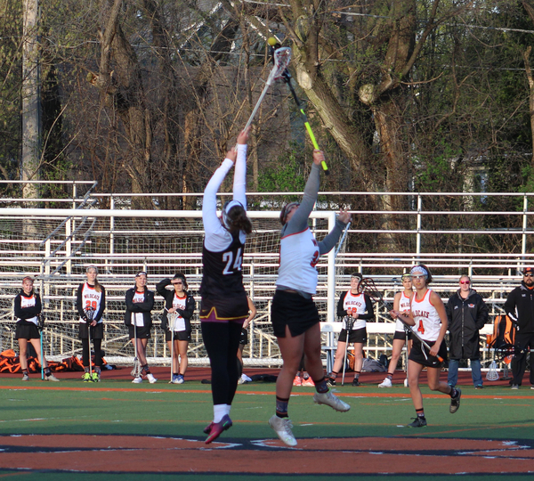 Freshman Emma Burns battles for the ball in the air after a draw.