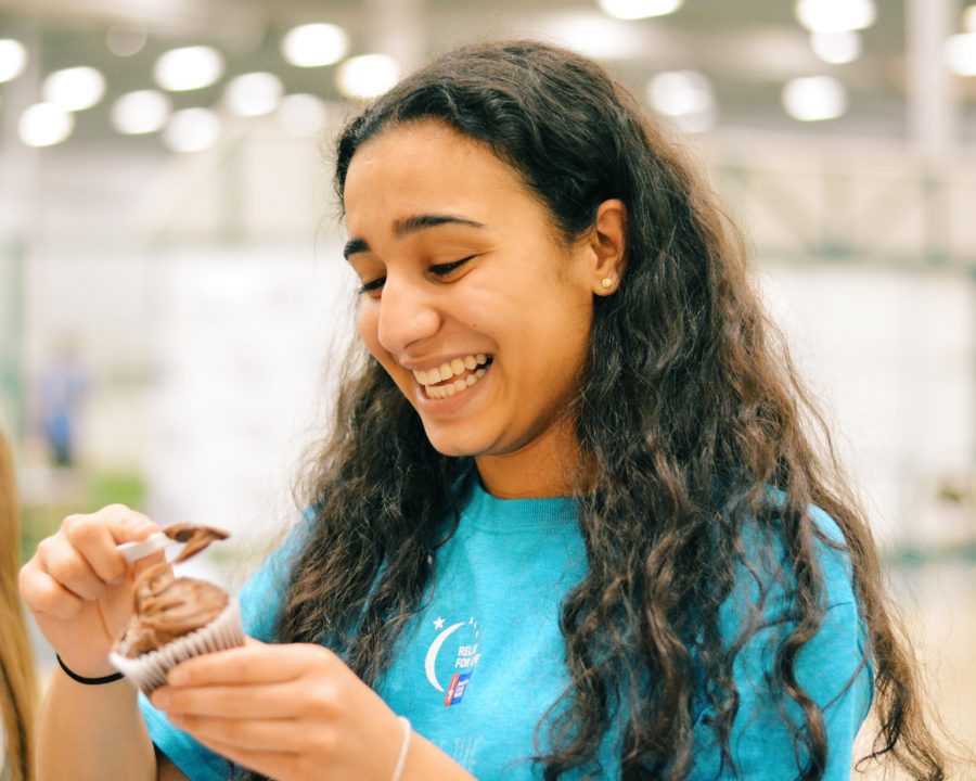 Junior and Relay for Life leader Aditi Mehra gleams as she decorates cupcakes as part of the activities for the Relay for Life lock-in.
