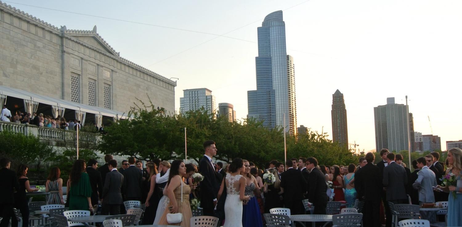 Prom attendees gather on the top and lower decks outside and socialize before re-entering the Shedd.