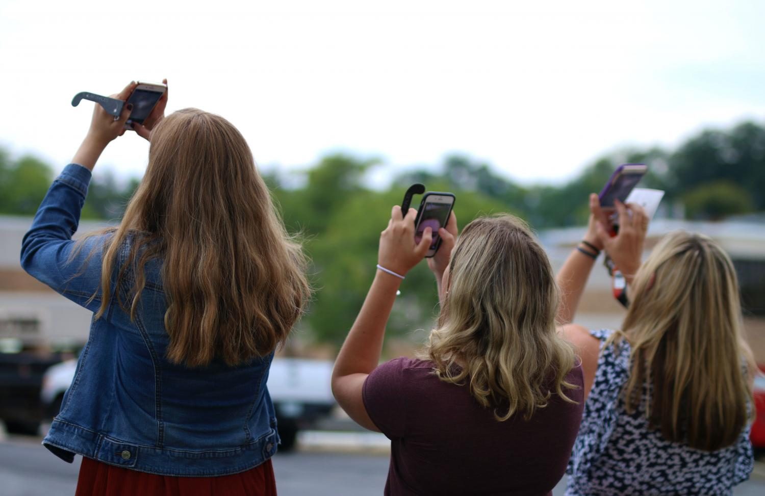 Others used their phones to view the eclipse, as it was not safe to look up with the naked eye, but it also was not visible at all times. 