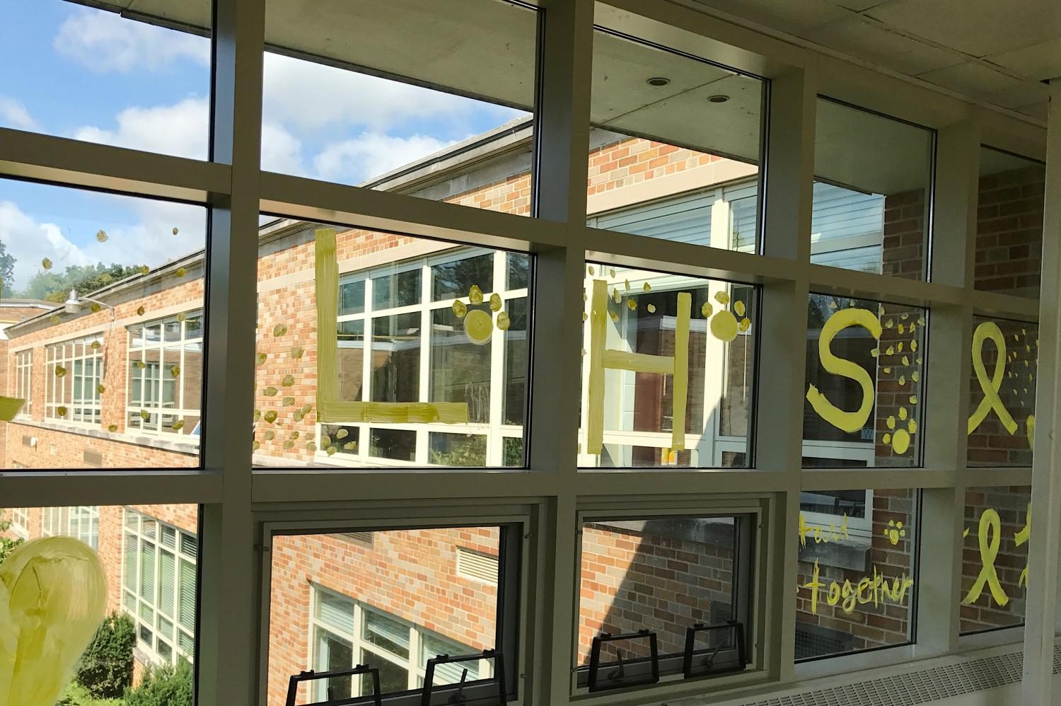 LHS students painted windows around the school to spread awareness about Yellow Ribbon week.