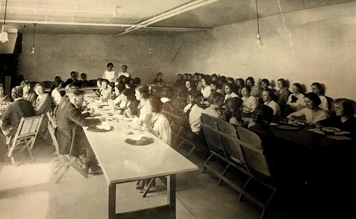Students enjoy a meal in the basement of the Brainerd building, where the cafeteria was located.