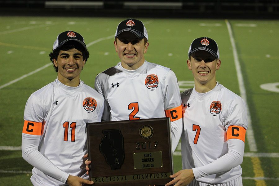 Senior captains (left to right) Greg Krikorian, Ryan Wittenbrink, and Riley Hoff with their hard-earned sectional plaque after their 8-1 win on Friday night at Fremd High School