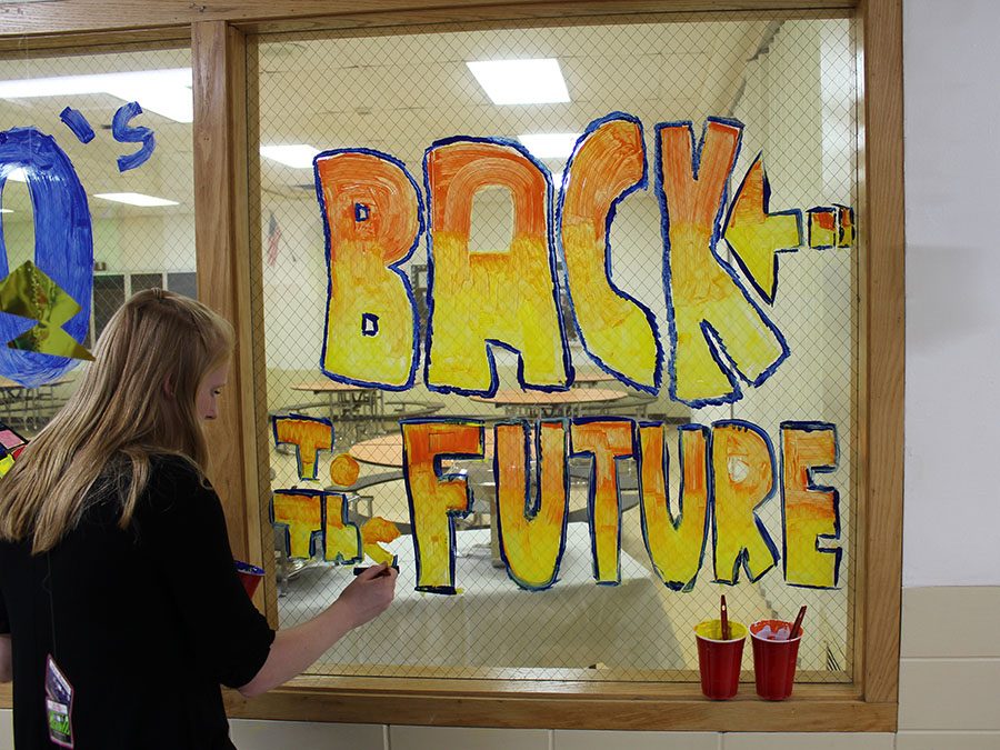 Senior Mary Cate Buchert painted the windows of the hallway with 1980s movies. Buchert also painted a picture of the movie “Clueless” and helped paint the picture of “Grease.” 
