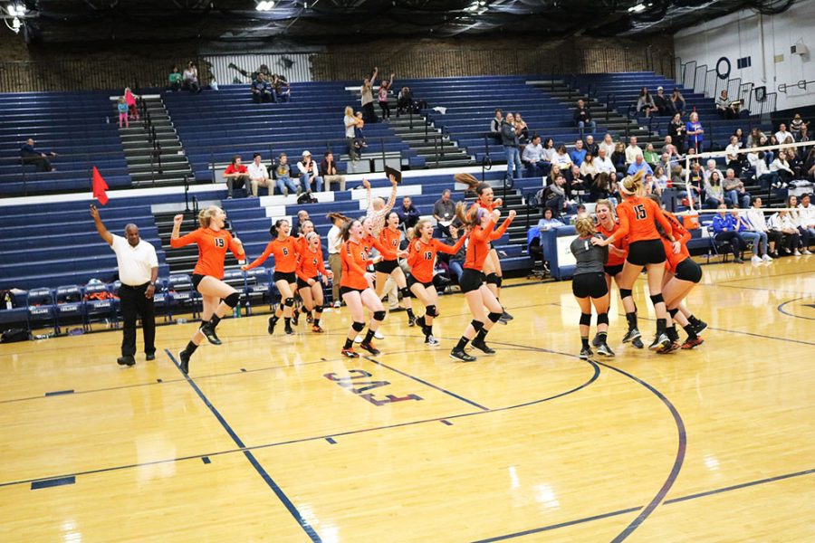 The Libertyville volleyball team celebrates their Regional Championship win, for the third consecutive year. 