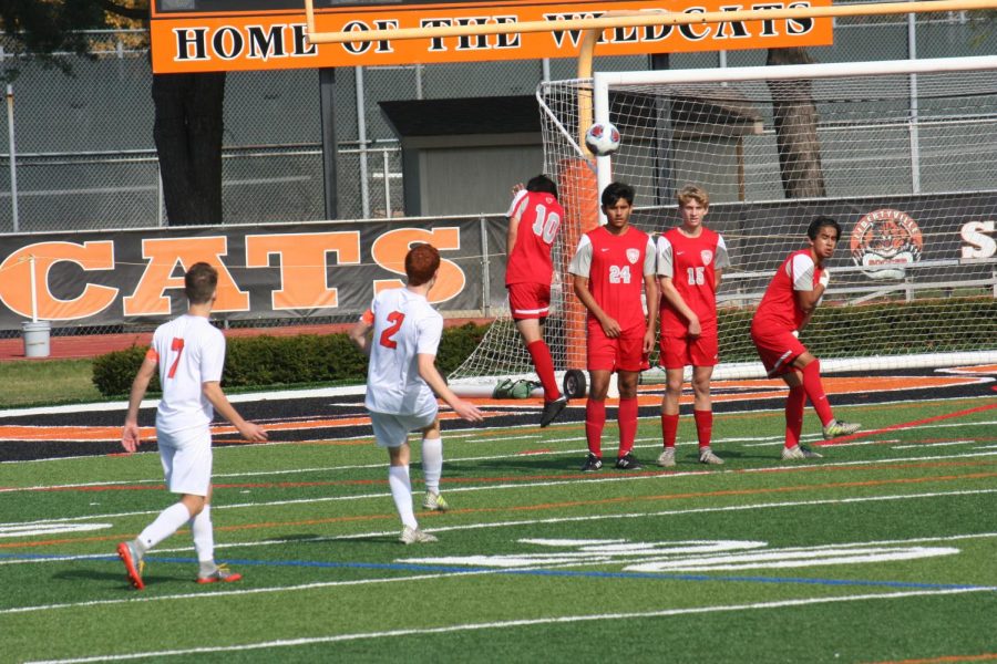 Ryan Wittenbrink (#2) kicks his first goal of the game over the head of three Mundelein defenders.
Photo courtesy of Maddy Wittenbrink