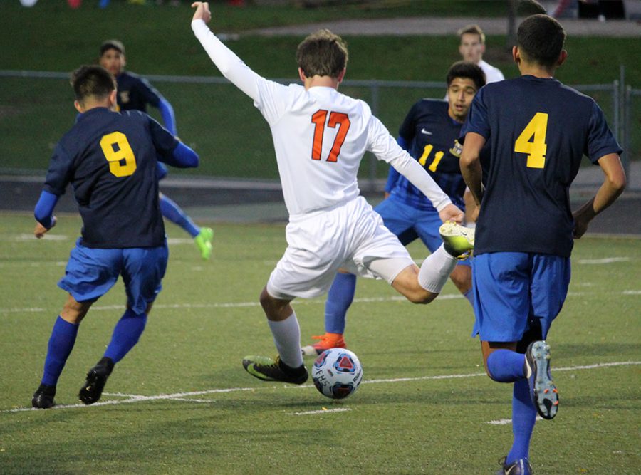 Tanner Kelly shoots the ball while surrounded by several Wheeling players.