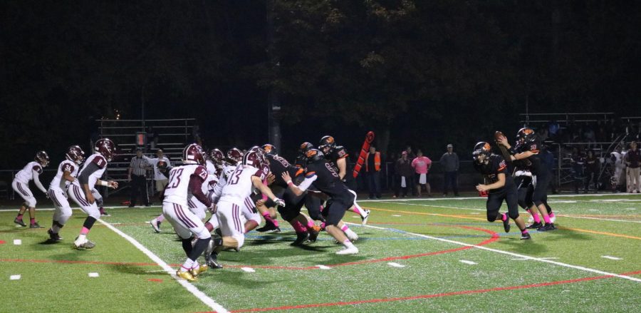 Varsity quarterback, senior Alex Stanulis, catches the ball from center, Luke Weiland, during the Wildcat’s win against the Zee-Bees.