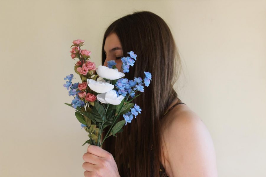 Tierney Keegan holds a bouquet of flowers resembling Ethereal Clothing Company's logo.