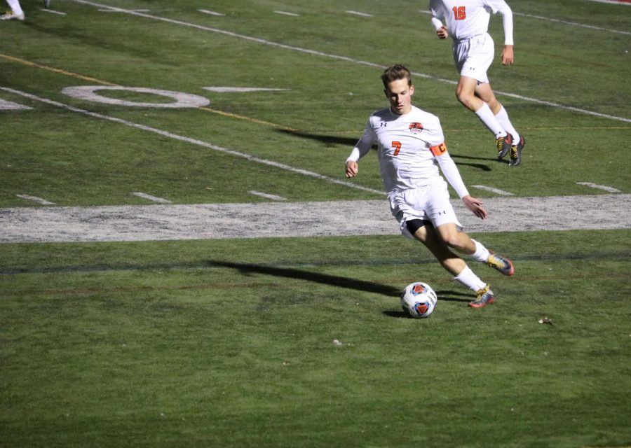 Riley Hoff, senior, dribbles the ball down the field for a goal attempt.