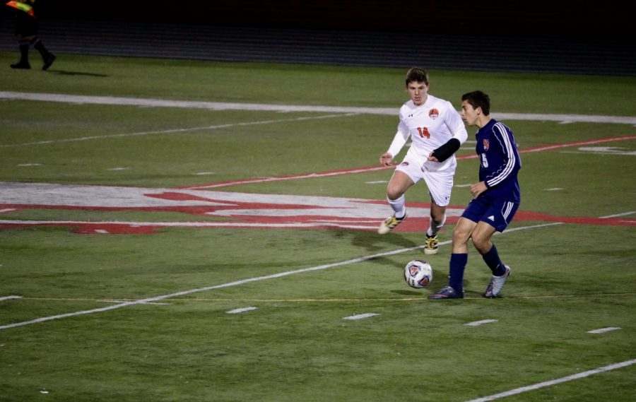 Senior Will Powers defends against a rush down the field for Evanston.