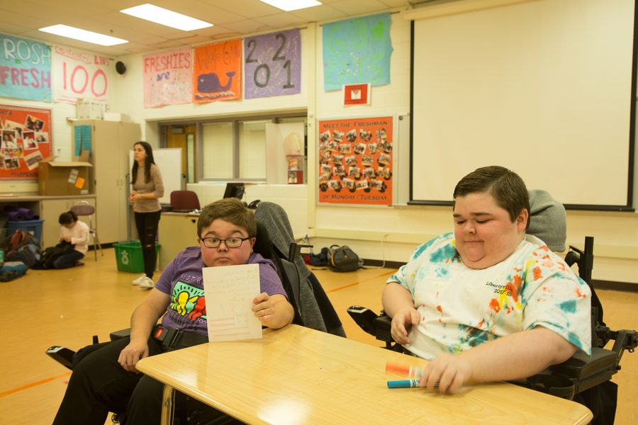 Clavey (left) reads Fisher’s Veteran’s Day letter, which he wrote as part of an activity at a recent meeting for Best Buddies, a club at LHS that unites and creates friendships between people with and without disabilities.