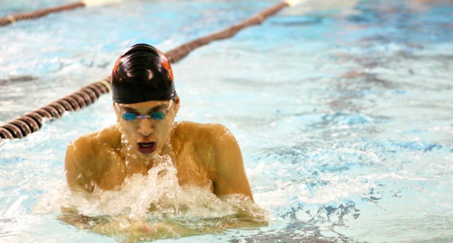 Varsity senior Austin Stevenson shoots up for a breath, finishing his 100M breaststroke with a time of 1:01.