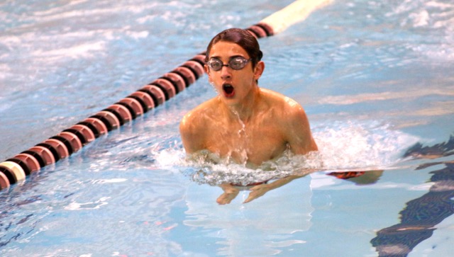 Freshman Simon Amyot comes up for a breath as he pulls himself through the water, finishing the 100M breaststroke with a time of 1:36.