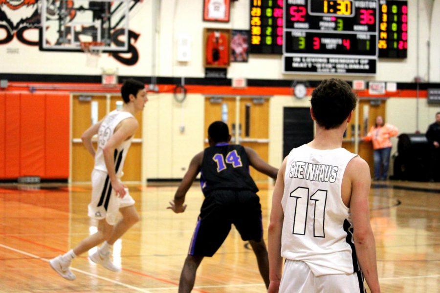 Junior Josh Steinhouse (11) watches teammate senior Drew Peterson (23) as he sets up an isolation play.