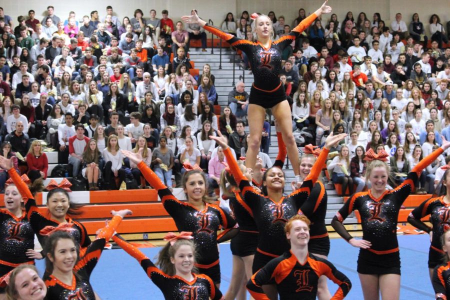 The varsity cheer team performed an energetic routine at the assembly to an upbeat mashup ending with Whitney Houston’s “How Will I Know.”