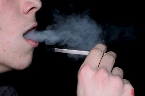 A LHS student taking a hit from a Juul. Students must be 18 and not involved in any school activities to use Juuls legally.
