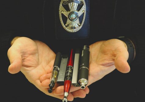 Mr. Dusan Racic, the LHS school resource officer, holding some of the confiscated Juuls from teachers in his hands. He is a sworn law enforcement officer that is responsible for providing security and crime prevention services to LHS.