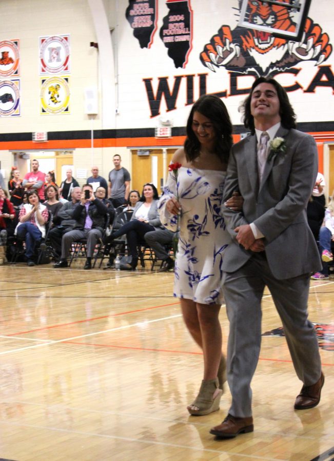 Turnabout court member Benjamin Arnold and honor court member Bridget Horvath walk together into the assembly.