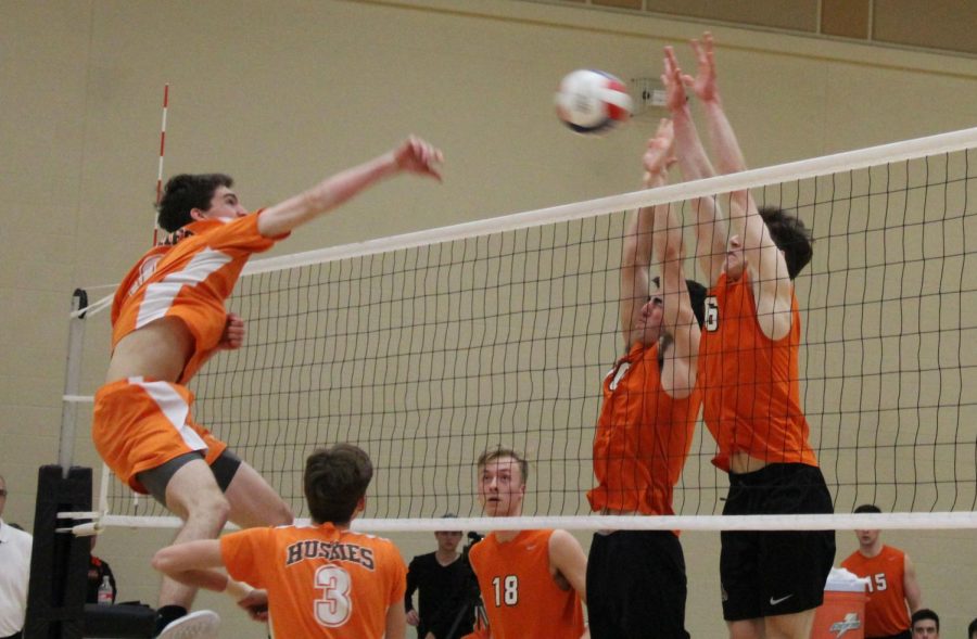 Seniors Zachary Ford, middle hitter (and also a member of the Drops of Ink staff) and Jack Stevens, outside hitter, (6) block a Hersey spike attempt.