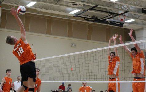 Senior opposite hitter Colin Hawkinson (18) attempts to get it past two Hersey defenders as they try to block his shot. Hawkinson ended with seven kills, two blocks and five digs.