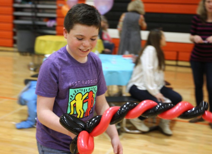 Chase Miller, a freshman, looks down contently at his balloon sword, which he used moments before to participate in a play fight with another student.