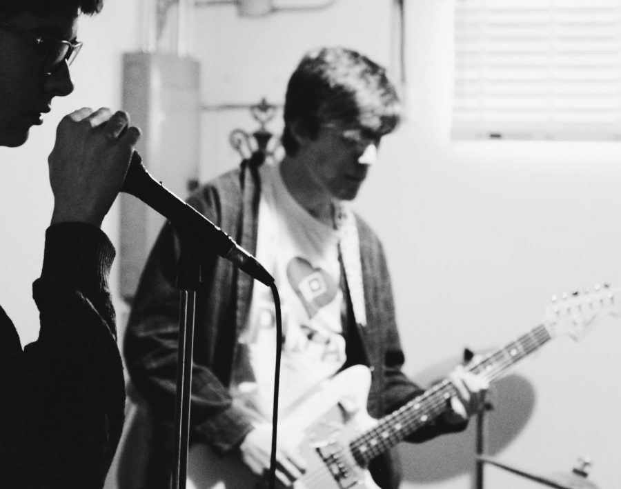 Both the band Poyo and Pt Cruiser often practice in the same space since they share band members. Senior Marty Brannaman (left) is the bass player for the band Poyo and sophomore Braeden Long is the lead guitarist for the band PT Cruiser. 