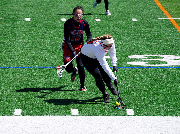 Sophomore Emma Burns beats a Conant player to a ground ball. Burns scored two goals during this game.