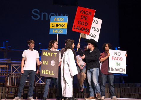 During the funeral for Shepard, as portrayed in the play, anti-LGBTQ+ citizens protested with homophobic signs, taunting those present who supported the Shepards.