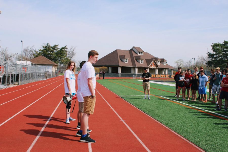 Sophomore Christian Voelker, junior Kylee Kraus and junior Ben Kanches stood on the track as they expressed their thoughts on the 2nd Amendment to a group of supporters on the football field.