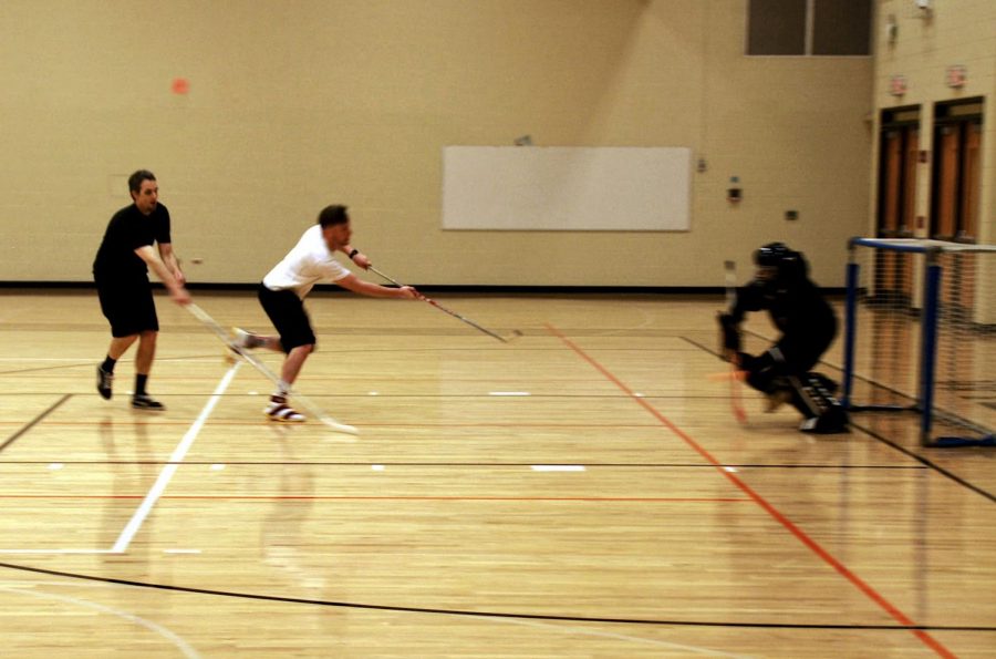 White makes a shot past Dr. Koulentes, who was the goalie for the black team. 