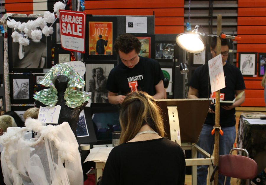 As part of his booth, senior Nate Sweitzer, who is a staff member on Drops of Ink, drew a portrait of students who were interested.