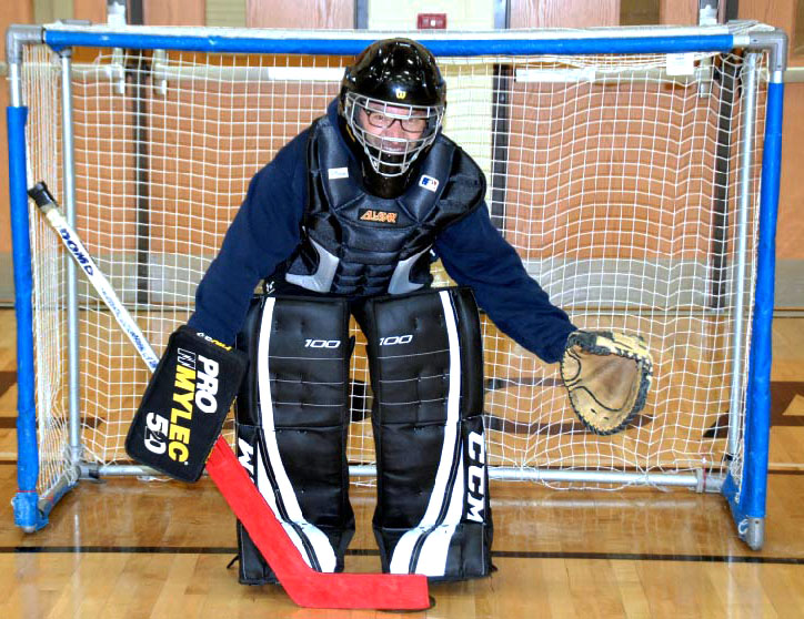 Principal Dr. Tom Koulentes, who plays goalie during the game, gets in position before the start of the second half. 