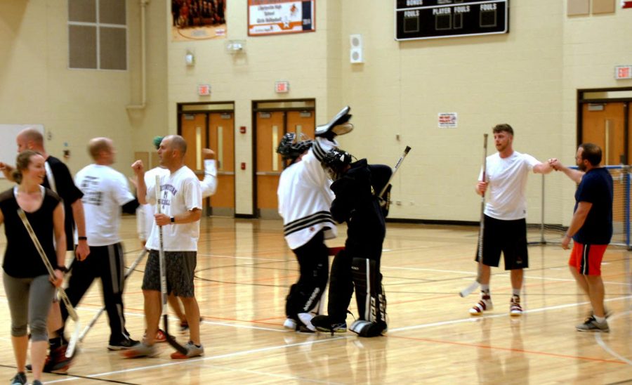 Goalies and players from each team celebrate the end of the game. The final score was 6-1, with the victory lying with the white team. 