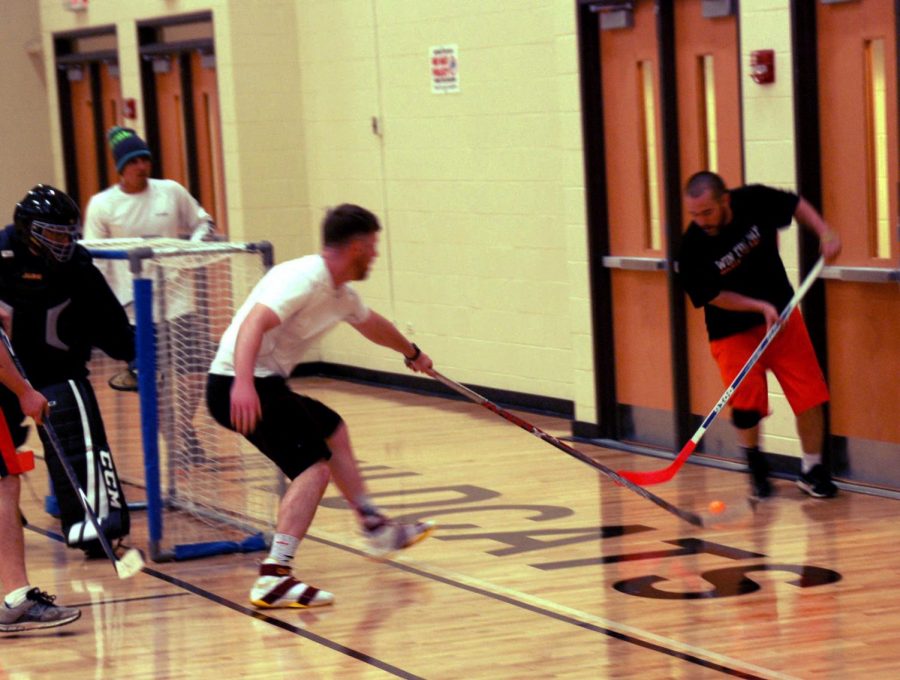 A player on the white team tries to get possession so he can take a shot on goal.