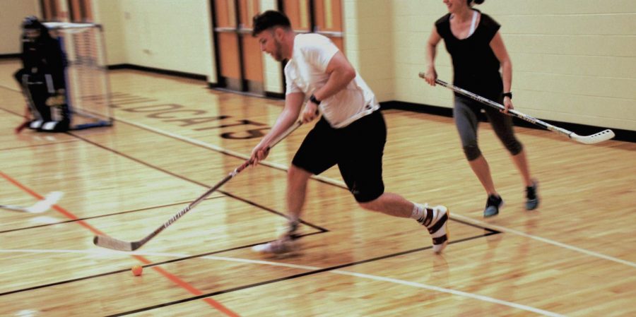 The white team wins possession, and the player maneuvers the ball towards the goal. 