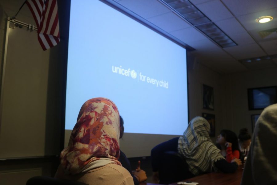 Students interested in UNICEF watch an informational video about how the organization helps children around the world.