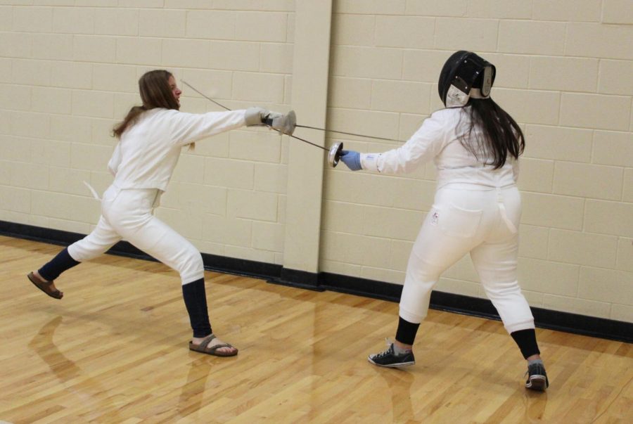 Although fencing is generally recognized as a sport, LHS offers it as a club. Seniors Anna Schellin and Charlotte Stevenson practice for a match.