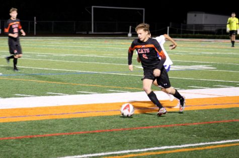 Senior Brandon Murphy attacks up the line while being chased down by a Lake Forest defender.