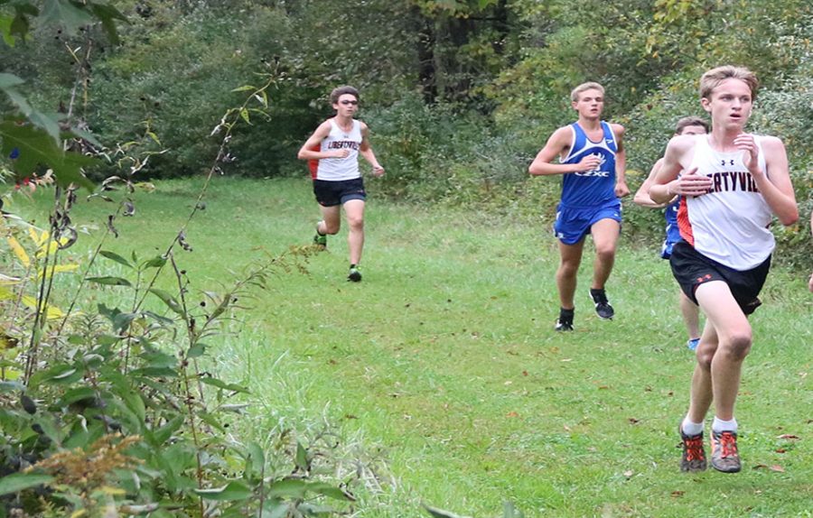 LHS sophomore Liam Tucker (right) and senior Jonathan Timm (left) run alongside their Lake Zurich opponents as they pass the one-mile mark.