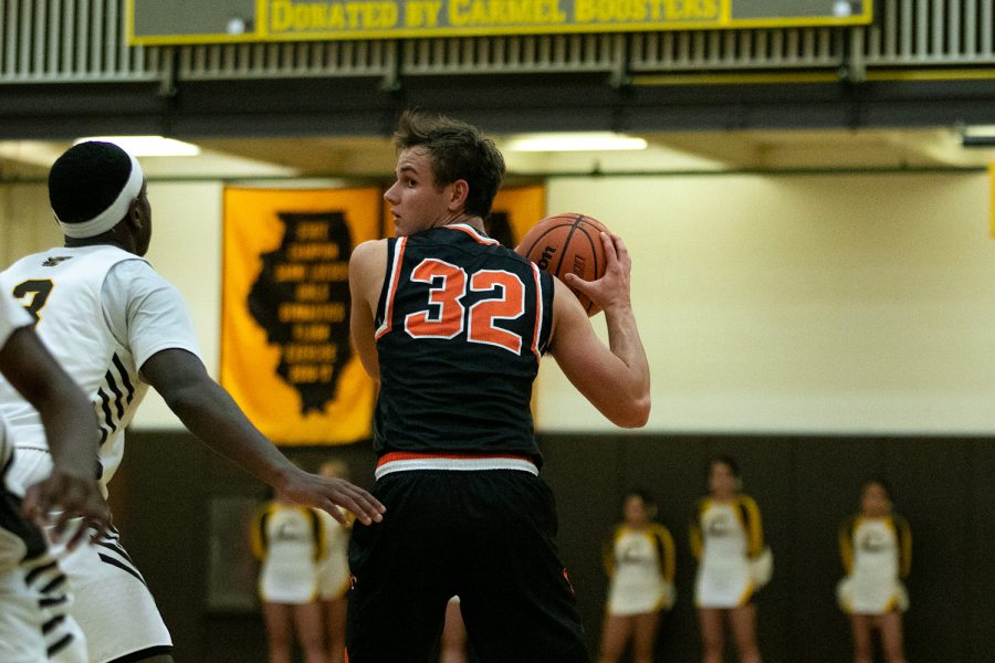 Surveying his options under the basket, Clark, at the three-point line, looks for a passing opportunity.