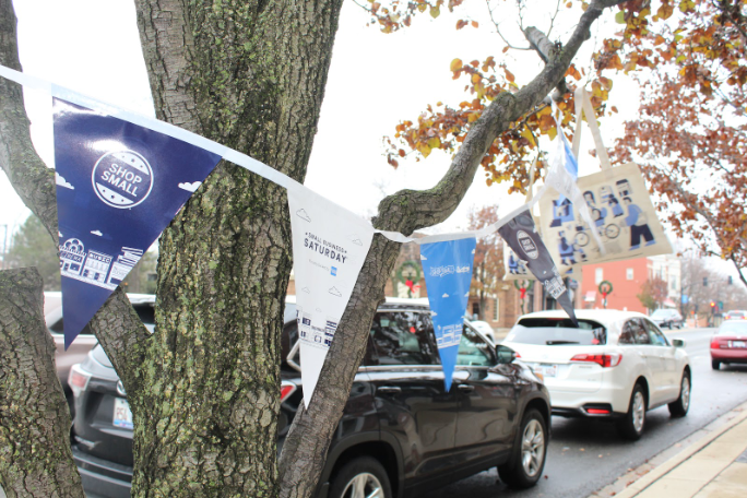 Some stores in downtown Libertyville that participated in Small Business Saturday promoted it by putting flags and bags with the logo on the trees in front of their shops.