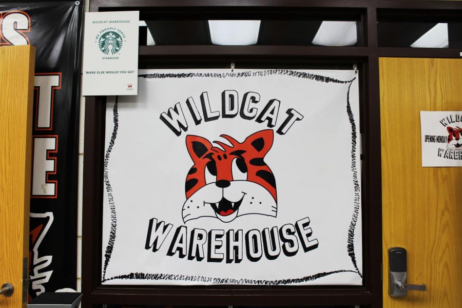 The+Wildcat+Warehouse+is+open+before+school+every+morning+in+the+main+lobby.+Their+logo%2C+featured+on+this+sign+hanging+next+to+the+Spirit+Store%2C+was+designed+by+senior+Brandon+Fisher.