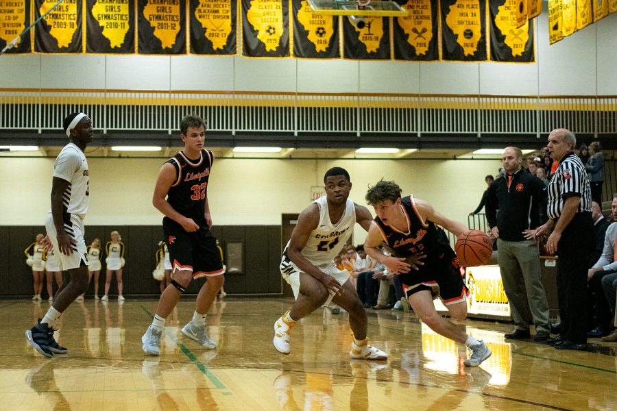 With Coach Brian Zyrkowski watching intensely, Steinhaus beats a defender and drives to the end line.