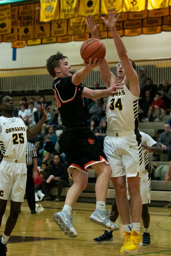 Driving towards the rim, Watson initiates contact with the defender and goes up for a layup.
