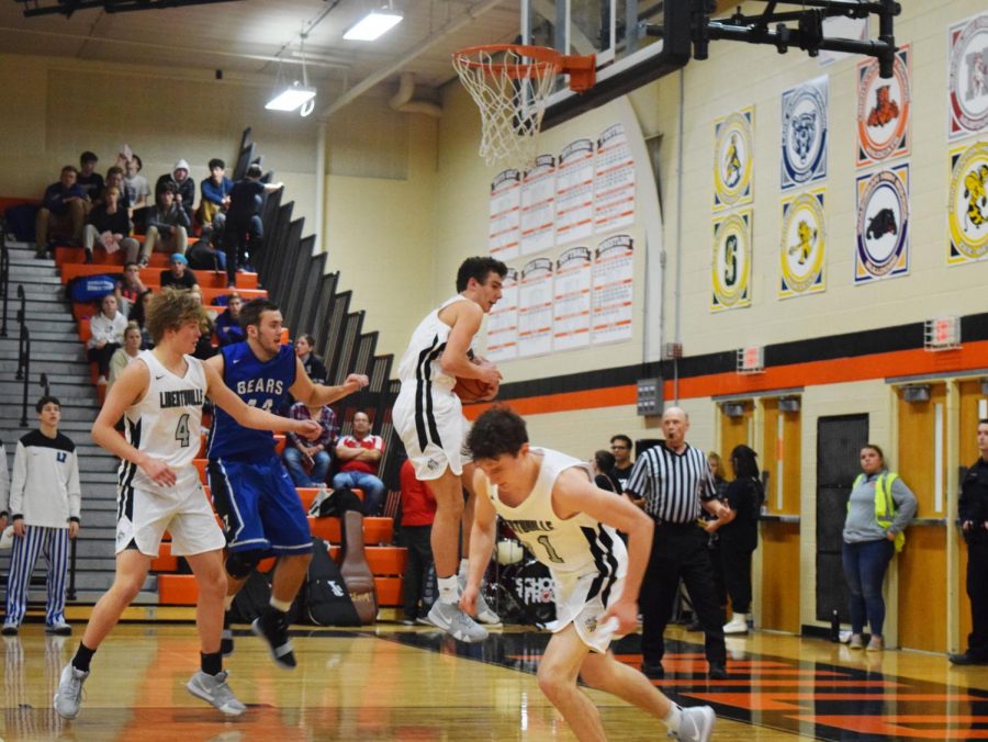 Wilterdink jumps up to grab the rebound while protecting the ball from his opponent, Nick Marcinkiewicz.