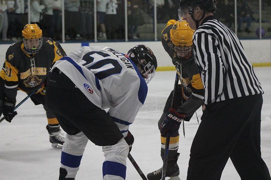 LHS Sophomore Chris Mulligan waits for the puck drop during a faceoff. 